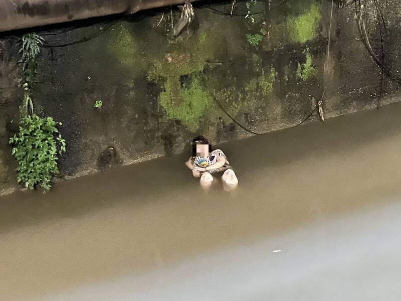 1名妇人晚间坐泡在莺歌溪中,基隆市消防队员布放绳索将她救出送医。(记者林嘉东翻摄) 1名妇人晚间坐泡在莺歌溪中,基隆市消防队员布放绳索将她救出送医。(记者林嘉东翻摄)