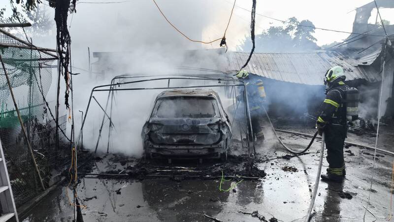 高雄住宅火警毁汽机车，父子受伤送医。（读者提供）