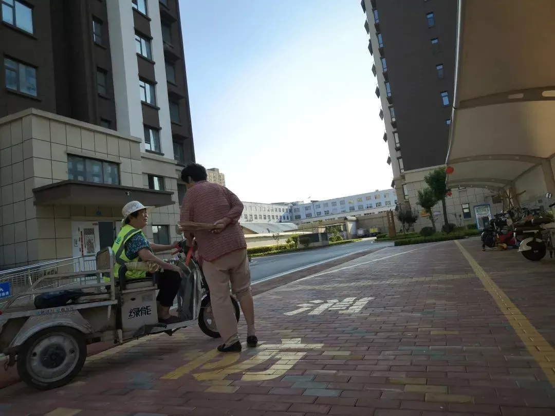 ◎ 大娘们在南村的电动车棚下聊天