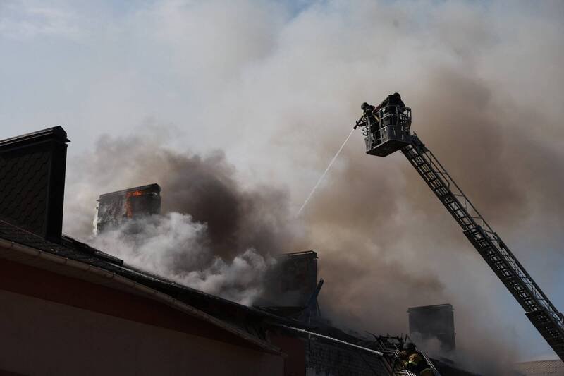 俄罗斯与乌克兰互相指控对方违反为期32小时的复活节停火协议。图为乌克兰札波罗热救援人员13日扑灭俄罗斯无人机袭击后燃烧的建筑物大火。（美联社） 